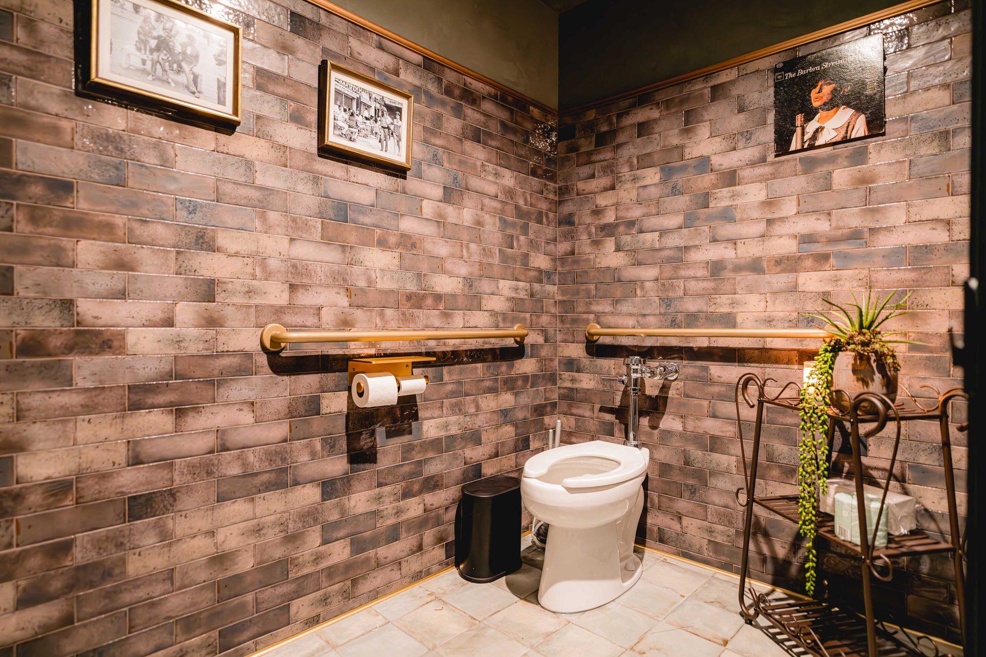 Carmel restroom clad in brick with raw timber shelving