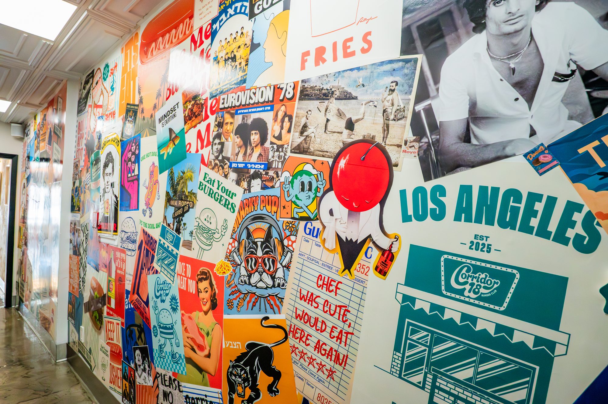 Collaged Los Angeles mural wall inside Corridor 18
