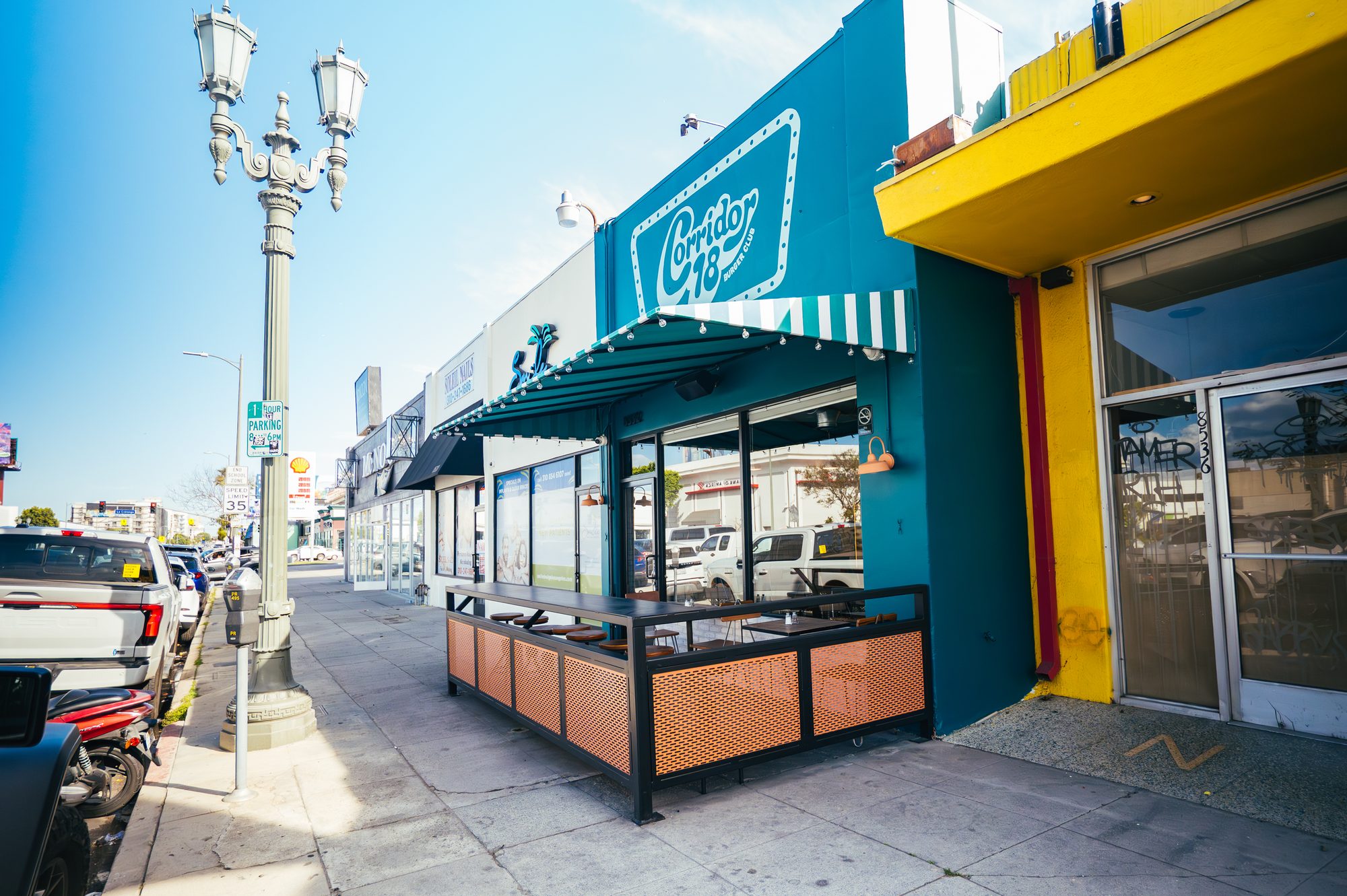 Corridor 18 storefront on Pico Boulevard with teal facade and striped awning