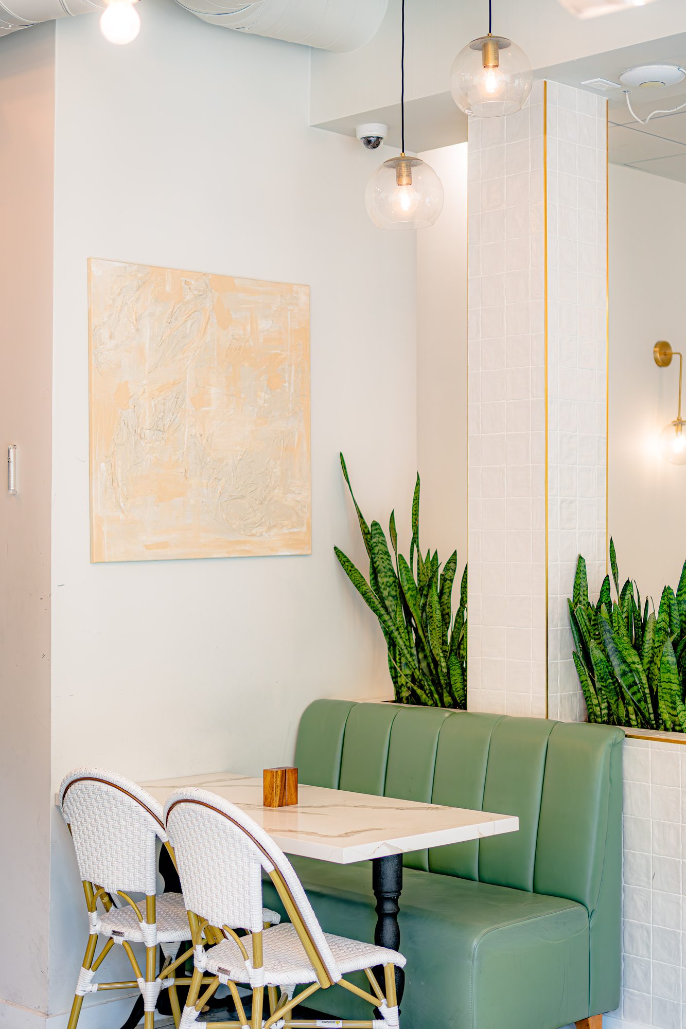 Corner table at Lamalo with textured artwork and green upholstery